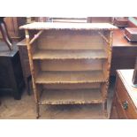 A bamboo three tier bookcase with rattan sides and shelves