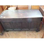 An 18th Century oak panelled coffer with later carving