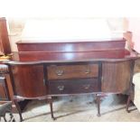 A mahogany sideboard with two central drawers flanked by cupboards on cabriole legs