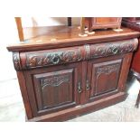 A carved Art Nouveau mahogany sideboard with two drawers and doors