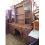 A light oak shelf back dresser with two glazed doors over single drawer,