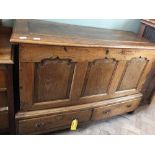 An 18th Century oak mule chest with carved panel fronts over two drawers