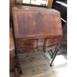 A mahogany and cross banded shape front bureau on cabriole legs