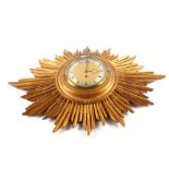 A giltwood sunburst wall clock