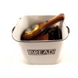 An enamel bread bin containing brassware etc