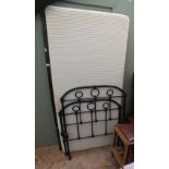 A black painted iron framed single bed