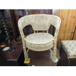 A cane tub chair, a circular cane and glass top occasional table,