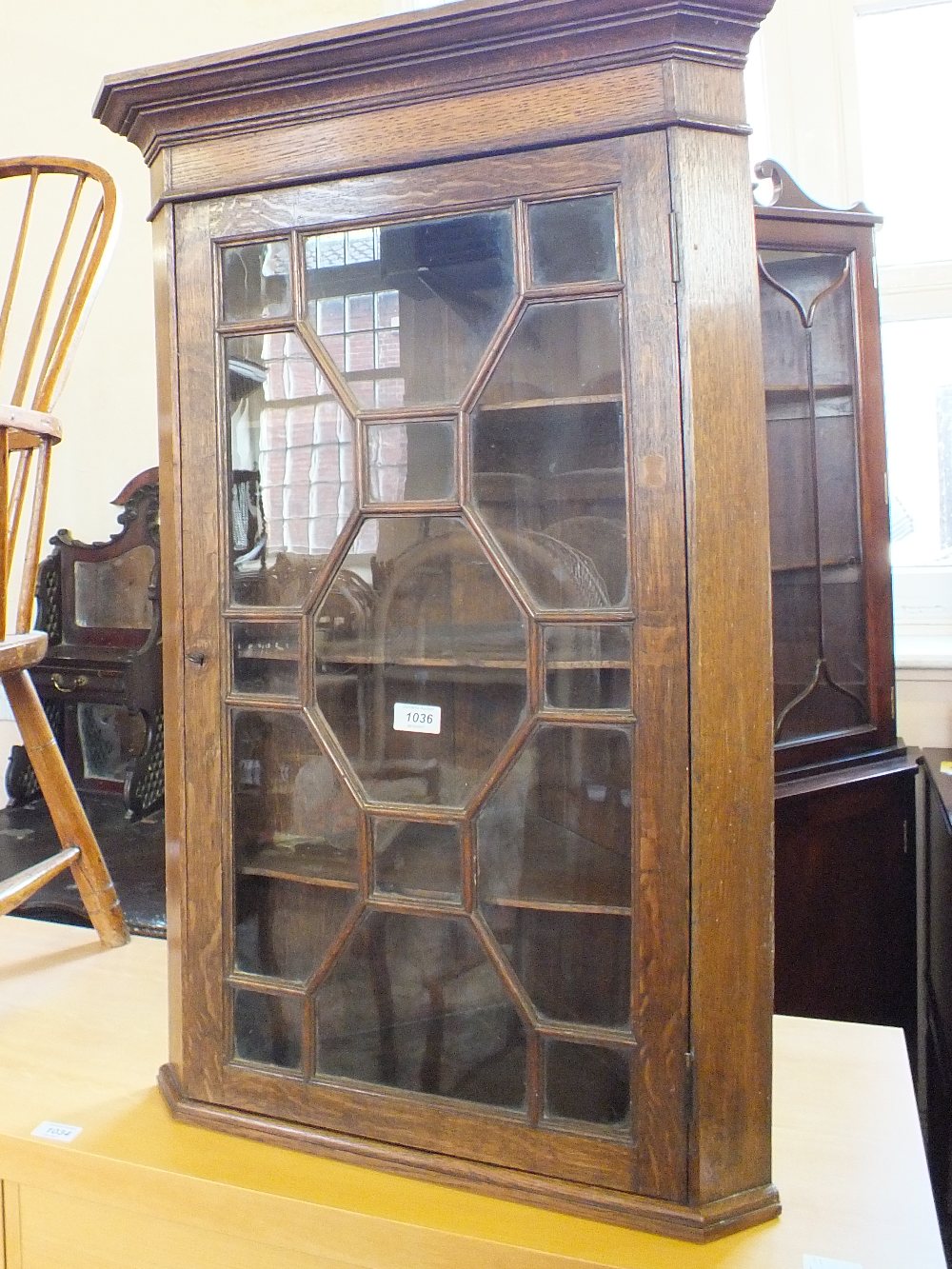 An oak glazed wall hanging corner cupboard