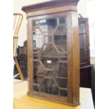 An oak glazed wall hanging corner cupboard