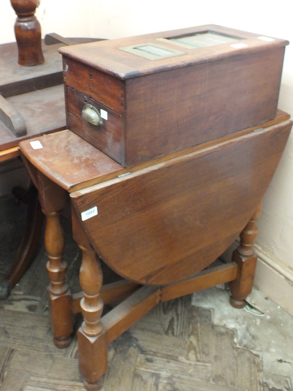 An oval gate leg table and a mahogany drawer cash till by G.H.