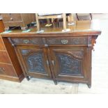 An Edwardian carved mahogany sideboard (back missing)