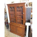 A reproduction mahogany astragal glazed bookcase sideboard