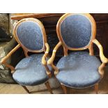 A pair of carved beechwood blue upholstered elbow chairs