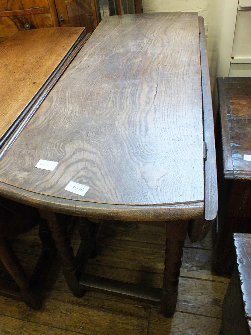 A 19th Century oak gate leg table on bobbin turned legs and an early 20th Century bi-fold wooden