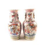 A pair of 19th Century Chinese pink ground figure and floral vases,