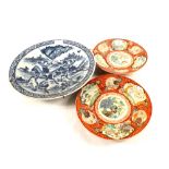 A pair of 19th Century Imari plates and a blue and white charger (cracked)