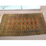 A Persian brown ground rug with multiple medallions,