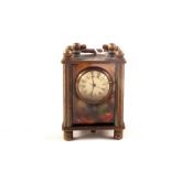 A miniature brass clock with picture glass panels