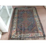 A Persian rug with two central medallions,