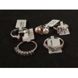 A group of five silver stone set rings including pearl,