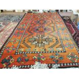 A Russian (possibly Kazak) red ground carpet with central medallions,