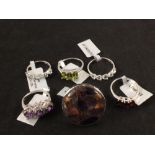 Six silver stone set rings including peridot, copper mojave,