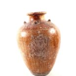 A Mediterranean terracotta jar with raised decoration and four ring handles,