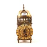 A mechanical clock in brass lantern style case