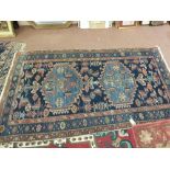 A Persian blue ground rug with two central medallions,