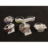 Six silver rings set with stones including topaz,