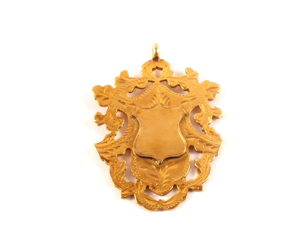 A 9ct gold medallion with unengraved centre