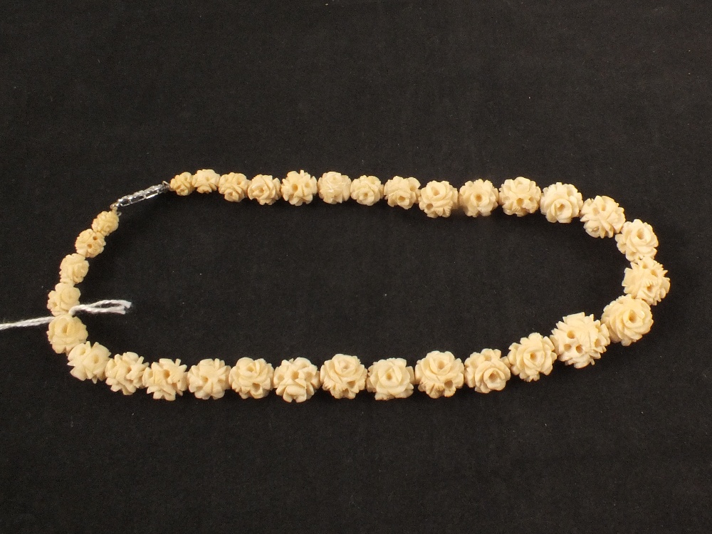 A carved ivory bead necklace