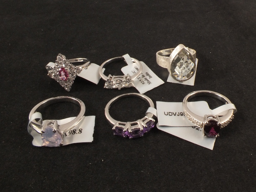 Six silver stone set rings including pink topaz,