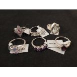 Six silver stone set rings including pink topaz,