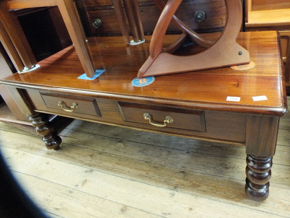 A large two drawer coffee table on turned legs