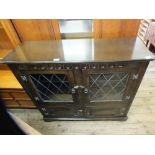 An Old Charm style twin door glazed cabinet with cupboards below