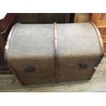 A vintage domed top canvas covered travelling trunk