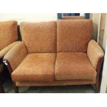 A modern wooden frame and terracotta upholstered three piece suite