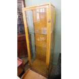 A light oak glazed single door shop display cabinet