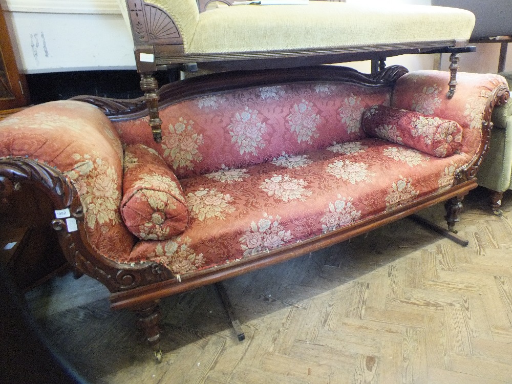 A Victorian scroll end three seat salon settee with floral upholstery,