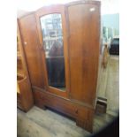 A 1930's triple wardrobe with single mirror and drawer below