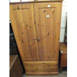 A pine double wardrobe with two drawers below