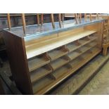 A glazed haberdashery shop display cabinet containing fifteen drawers with glass top and front