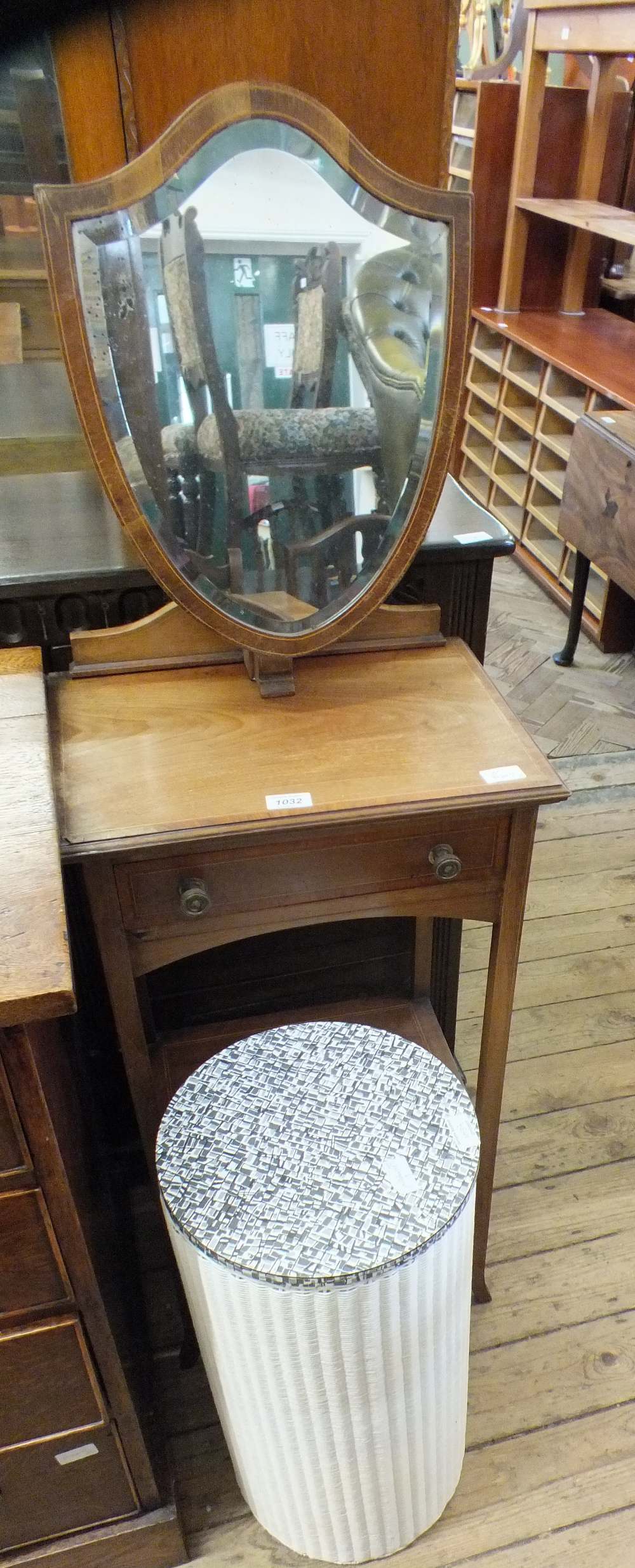 A gentleman's washstand with shield mirror and a circular Lloyd loom linen bin