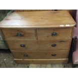 A stripped pine chest of two short and two long drawers