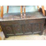 An 18th Century oak panelled coffer with later carving