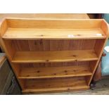 A pine four shelf floor standing bookcase and a satinwood chest of two short and two long drawers