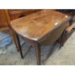 A mahogany oval flap leaf table with one drawer and one faux drawer on brass castors