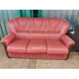 A modern Italian style wood and terracotta leather upholstered sofa