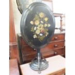 A Victorian papier mache folding tilt top table with painted floral decoration on turned column